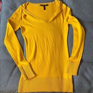 BCBGMaxAzaria Woman’s Cotton V Neck Long Sleeve Open Shoulder Sweater in Honey.